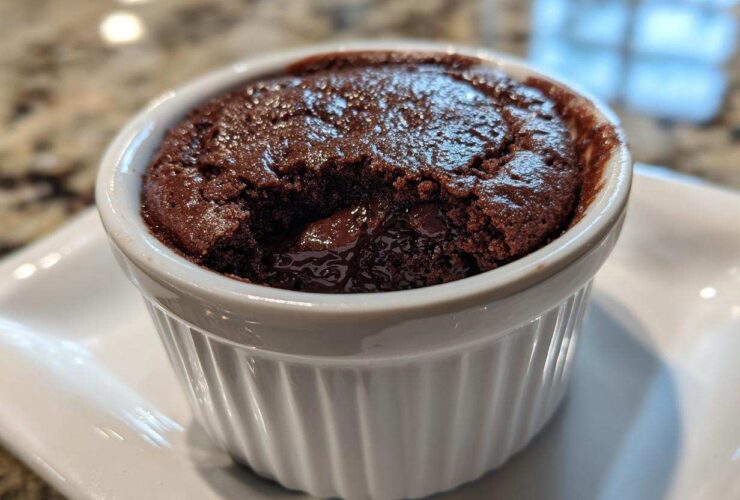 Close-up of a warm Cottage Cheese Microwave Brownie with a molten center served in a white fluted ramekin.