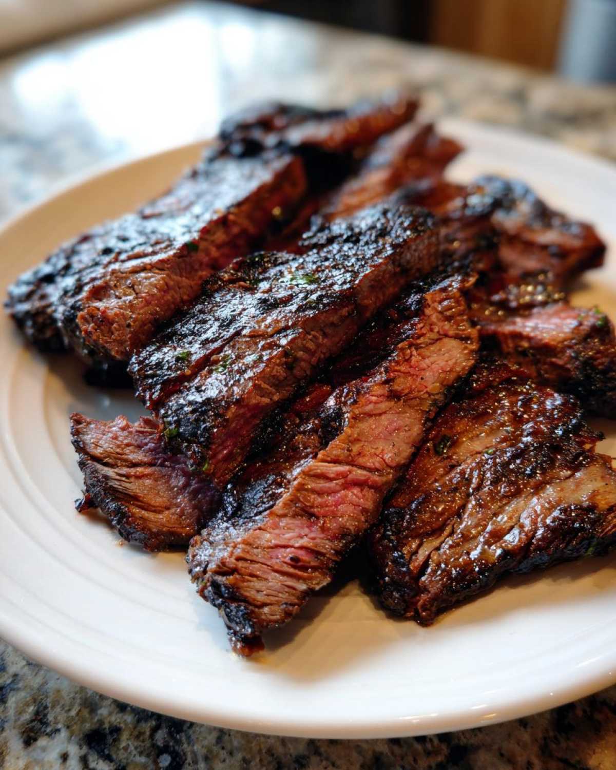 Close-up of sliced, grilled steak showing a juicy medium-rare center, achieved with the best carne asada marinade.