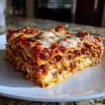 A thick, layered slice of Lasagna with Cottage Cheese topped with melted mozzarella and rich meat sauce.