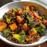 Close-up of a hearty veggie lentil salad featuring roasted sweet potatoes and charred broccoli florets mixed with brown lentils.