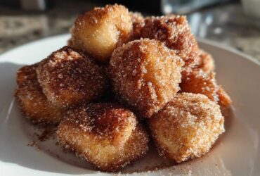 Close-up of golden Air Fryer Cinnamon Sugar Churro Bites heavily coated in sparkling cinnamon sugar.