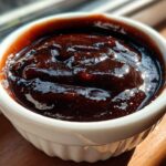 Close-up of thick, dark Copycat Chick-fil-A Honey Roasted BBQ Sauce in a white ramekin.
