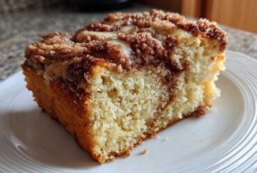 Close-up of a moist slice of Gluten-Free Cinnamon Sugar Coffee Cake with a crumbly cinnamon topping.