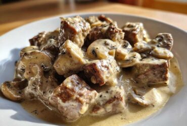 Close-up of tender beef cubes and sliced mushrooms coated in a creamy sauce for Instant Pot Beef Stroganoff with Mushrooms.