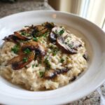 A close-up of creamy Instant Pot Creamy Mushroom Risotto topped with sautéed mushrooms and parsley.