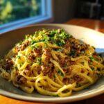 A close-up of One-Pot Creamy Garlic Butter Beef Noodles topped with fresh parsley.