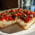 A thick slice of bread topped with creamy cheese and roasted tomatoes, representing the amazing bruschetta dip.