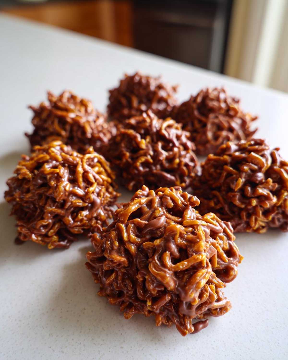 A cluster of rich, chocolate haystack cookies made with chow mein noodles, ready to eat.