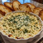 A bubbling, hot cheesy bread dip topped with parsley, served with toasted bread slices for dipping.