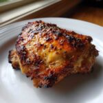 Close-up of a perfectly cooked Air Fryer Garlic Parmesan Chicken Thighs with crispy, golden-brown skin.
