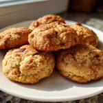 A pile of six soft, golden Banana Bread Cookies dusted with cinnamon sugar on a white plate.
