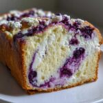 Cross-section view of a rich Blueberry Cream Cheese Bread Loaf showing swirls of cream cheese and blueberries in the moist crumb.