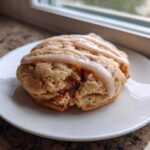 A single, thick Brown Sugar Pop Tart Cookie topped with a light brown sugar glaze, resting on a white plate.
