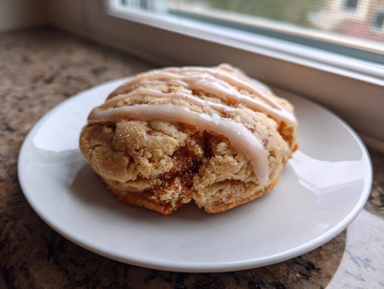 A single, thick Brown Sugar Pop Tart Cookie topped with a light brown sugar glaze, resting on a white plate.