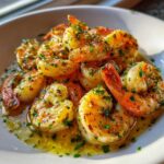 A close-up of succulent Lemon Garlic Shrimp coated in a rich, buttery sauce and sprinkled generously with fresh parsley.
