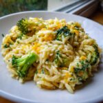 Close-up of a serving of creamy One Pot Broccoli Cheese Orzo with melted cheddar and bright green broccoli florets.