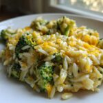 Close-up of a creamy serving of One Pot Broccoli Cheese Orzo topped with melted cheddar cheese.