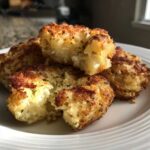 Close-up of golden brown Parmesan Crusted Smashed Potatoes, showing the crispy exterior and fluffy interior.