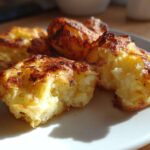 Close-up of golden brown, crispy Parmesan Crusted Smashed Potatoes on a white plate.