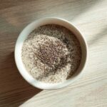 Overhead view of a white bowl filled with creamy Chia Seed Pudding, topped with extra chia seeds.